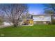 Charming home featuring a spacious front yard and a bright yellow front door at 1708 Fox Hill Dr, Indianapolis, IN 46228