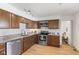 Well-lit kitchen featuring wooden cabinets, stainless steel appliances, and granite countertops at 1708 Fox Hill Dr, Indianapolis, IN 46228