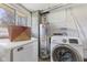 Functional laundry room equipped with modern washer, dryer, and storage options at 1708 Fox Hill Dr, Indianapolis, IN 46228