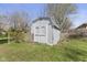 A well-maintained shed in a backyard with a lattice fence at 1708 Fox Hill Dr, Indianapolis, IN 46228