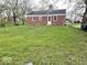 Expansive backyard with lush lawn and mature trees, perfect for outdoor activities at 2120 Sheffield Ave, Anderson, IN 46011