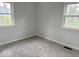 Cozy bedroom with freshly cleaned carpet and ample natural light from the windows at 2120 Sheffield Ave, Anderson, IN 46011