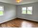 Bright bedroom with hardwood floors and ample natural light from the windows at 2120 Sheffield Ave, Anderson, IN 46011