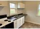 Functional kitchen featuring white cabinets, laminate countertops and essential appliances at 2120 Sheffield Ave, Anderson, IN 46011