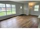 Bright and spacious living room featuring large windows and beautiful hardwood floors at 2120 Sheffield Ave, Anderson, IN 46011
