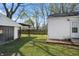 Green backyard with a detached garage, covered patio, and lush lawn at 2221 Groff Ave, Indianapolis, IN 46222