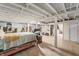 Unfinished basement featuring an open ceiling, painted beams and supports, and vintage-look flooring at 2221 Groff Ave, Indianapolis, IN 46222