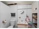Basement bathroom featuring white-painted brick walls and older vanity at 2221 Groff Ave, Indianapolis, IN 46222