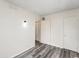 Bright bedroom featuring a wall sconce, neutral walls, and gray wood-look flooring at 2221 Groff Ave, Indianapolis, IN 46222
