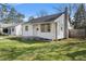 Cozy single-story home with wood siding, a chimney, and a well-manicured front lawn at 2221 Groff Ave, Indianapolis, IN 46222
