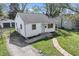 Aerial view of a quaint home with white siding, brown trim, and a brick walkway leading to the front door at 2221 Groff Ave, Indianapolis, IN 46222