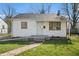 Charming single-story home with a brick walkway, white siding, and well-maintained front lawn at 2221 Groff Ave, Indianapolis, IN 46222