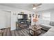 Cozy living room featuring modern flooring, a ceiling fan, and an electric fireplace entertainment center at 2221 Groff Ave, Indianapolis, IN 46222