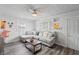 Comfortable living area boasting a large sectional sofa, ceiling fan, and updated flooring at 2221 Groff Ave, Indianapolis, IN 46222