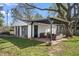 Covered outdoor patio with seating and shade, adjoining a detached garage in the backyard at 2221 Groff Ave, Indianapolis, IN 46222