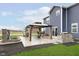 Outdoor oasis with a covered patio featuring comfortable seating, a built-in grill, and charming water feature at 2538 Redding Dr, Whitestown, IN 46075