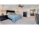 Inviting bedroom with blue quilted bedspread and modern ceiling fan and lamps at 2538 Redding Dr, Whitestown, IN 46075