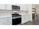 Close-up of a kitchen featuring stainless steel appliances, white cabinets, and light countertops at 2538 Redding Dr, Whitestown, IN 46075