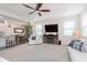 Bright living room featuring neutral decor, a ceiling fan, and a cozy fireplace entertainment center at 2538 Redding Dr, Whitestown, IN 46075