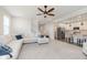 Open-concept living space with seamless flow to a modern kitchen and plush white furnishings at 2538 Redding Dr, Whitestown, IN 46075