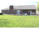 Expansive backyard featuring a brick house with a covered patio, perfect for outdoor entertaining at 2692 E County Road 750 S, Clayton, IN 46118