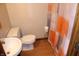 A bright bathroom features a shower with patterned curtain, a toilet, and a sink at 2692 E County Road 750 S, Clayton, IN 46118