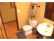 Cozy bathroom featuring decorative sunflowers, a toilet and a sink with rustic decor at 2692 E County Road 750 S, Clayton, IN 46118