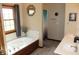 A modern bathroom featuring a soaking tub and double sinks with tiled floors at 2692 E County Road 750 S, Clayton, IN 46118