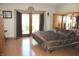Well-lit bedroom with a mirrored closet, brown bedding, and French doors to the outside at 2692 E County Road 750 S, Clayton, IN 46118