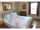Light-filled bedroom with a metal-framed bed, soft-toned bedding and wood floors at 2692 E County Road 750 S, Clayton, IN 46118