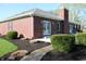 A beautiful brick home featuring a well-maintained yard, a brick chimney, and a cozy patio area at 2692 E County Road 750 S, Clayton, IN 46118