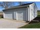 Spacious detached two-car garage with white doors and gravel driveway, offering ample parking at 2692 E County Road 750 S, Clayton, IN 46118
