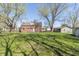 The home has a spacious backyard with mature trees surrounding the house, offering a large area to enjoy at 2741 Mars Hill St, Indianapolis, IN 46241