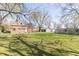 Large backyard with chain link fence and mature trees at 2741 Mars Hill St, Indianapolis, IN 46241