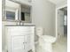 Bathroom with white vanity, framed mirror, and toilet at 2741 Mars Hill St, Indianapolis, IN 46241
