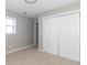 Bedroom with gray walls, carpet, and a closet with sliding doors at 2741 Mars Hill St, Indianapolis, IN 46241