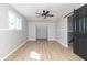 A bright bedroom features a modern ceiling fan, stylish sliding barn door, and light wood flooring at 2741 Mars Hill St, Indianapolis, IN 46241
