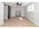 A bright bedroom features a modern ceiling fan, stylish sliding barn door, and light wood flooring at 2741 Mars Hill St, Indianapolis, IN 46241