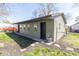 View of the detached garage highlighting the siding and the three windows facing the lawn at 2741 Mars Hill St, Indianapolis, IN 46241