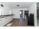 Bright kitchen features white cabinets, black appliances and wood-look flooring at 2741 Mars Hill St, Indianapolis, IN 46241