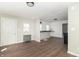 Spacious open-concept living room highlighting grey tones and the kitchen with breakfast bar in the background at 2741 Mars Hill St, Indianapolis, IN 46241