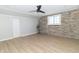 Well-lit living space with stone accent wall and updated floors at 2741 Mars Hill St, Indianapolis, IN 46241