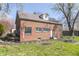 Rear exterior of a brick home featuring a well-maintained backyard, patio, and mature trees at 2741 Mars Hill St, Indianapolis, IN 46241