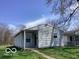 Side view of a quaint single-story house with a well-kept lawn, showcasing its simple architecture at 2823 N Gladstone Ave, Indianapolis, IN 46218