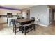 Open kitchen and dining area featuring gray walls, wood floors, a large dining table, and white cabinets at 2960 W Patchwork Dr, Monrovia, IN 46157