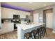 Modern kitchen featuring white cabinets, marble countertops, stainless steel appliances, and a kitchen island with seating at 2960 W Patchwork Dr, Monrovia, IN 46157