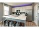 Modern kitchen featuring white cabinets, marble countertops, stainless steel appliances, and a kitchen island with seating at 2960 W Patchwork Dr, Monrovia, IN 46157