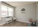 Bright and airy room with light gray walls, wood floors, and a large window with white curtains at 2960 W Patchwork Dr, Monrovia, IN 46157