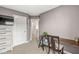 Neutral bedroom with a built-in desk and view into a connecting hallway at 3527 Brampton Ln, Westfield, IN 46074