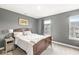 Comfortable bedroom boasts great natural light, a wood bedframe and a playful championship print at 3527 Brampton Ln, Westfield, IN 46074